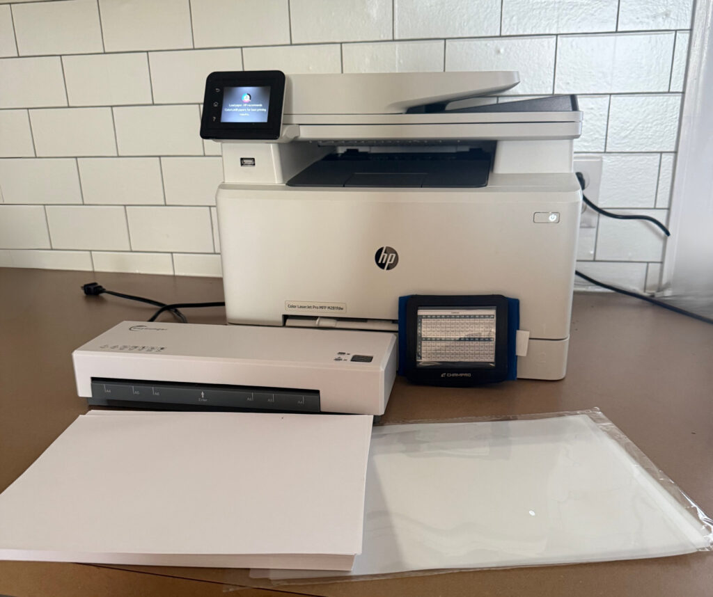 Supplies needed to create armband printer, laminator, armbands, paper, laminating paper